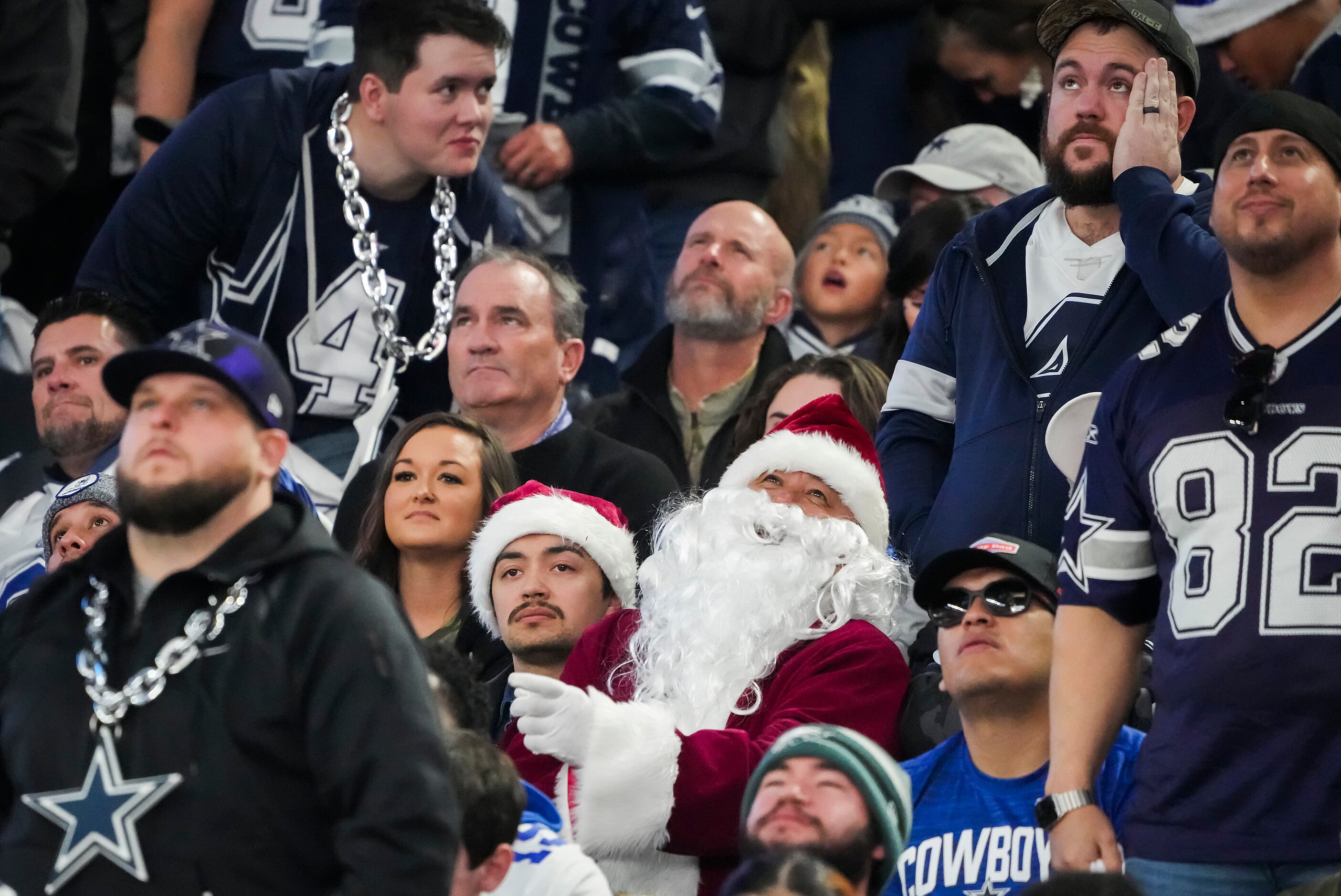 A Dallas Cowboys fan and a Philadelphia Eagles fan pose for a