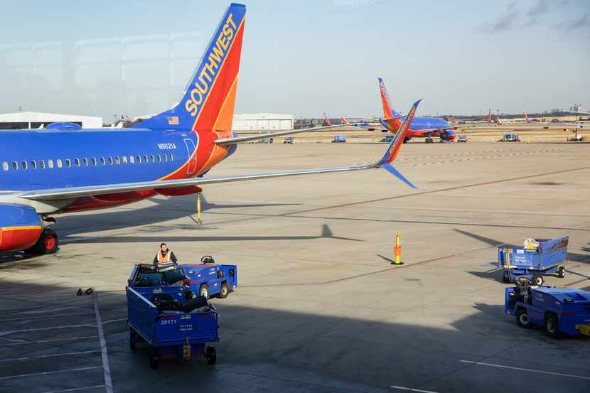 Southwest planes sit on the runway at Dallas Love Field Airport in Dallas on Wednesday, Dec....