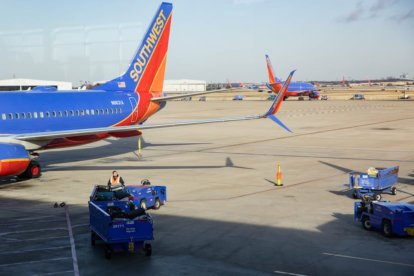 Southwest planes sit on the runway at Dallas Love Field Airport in Dallas on Dec. 23.