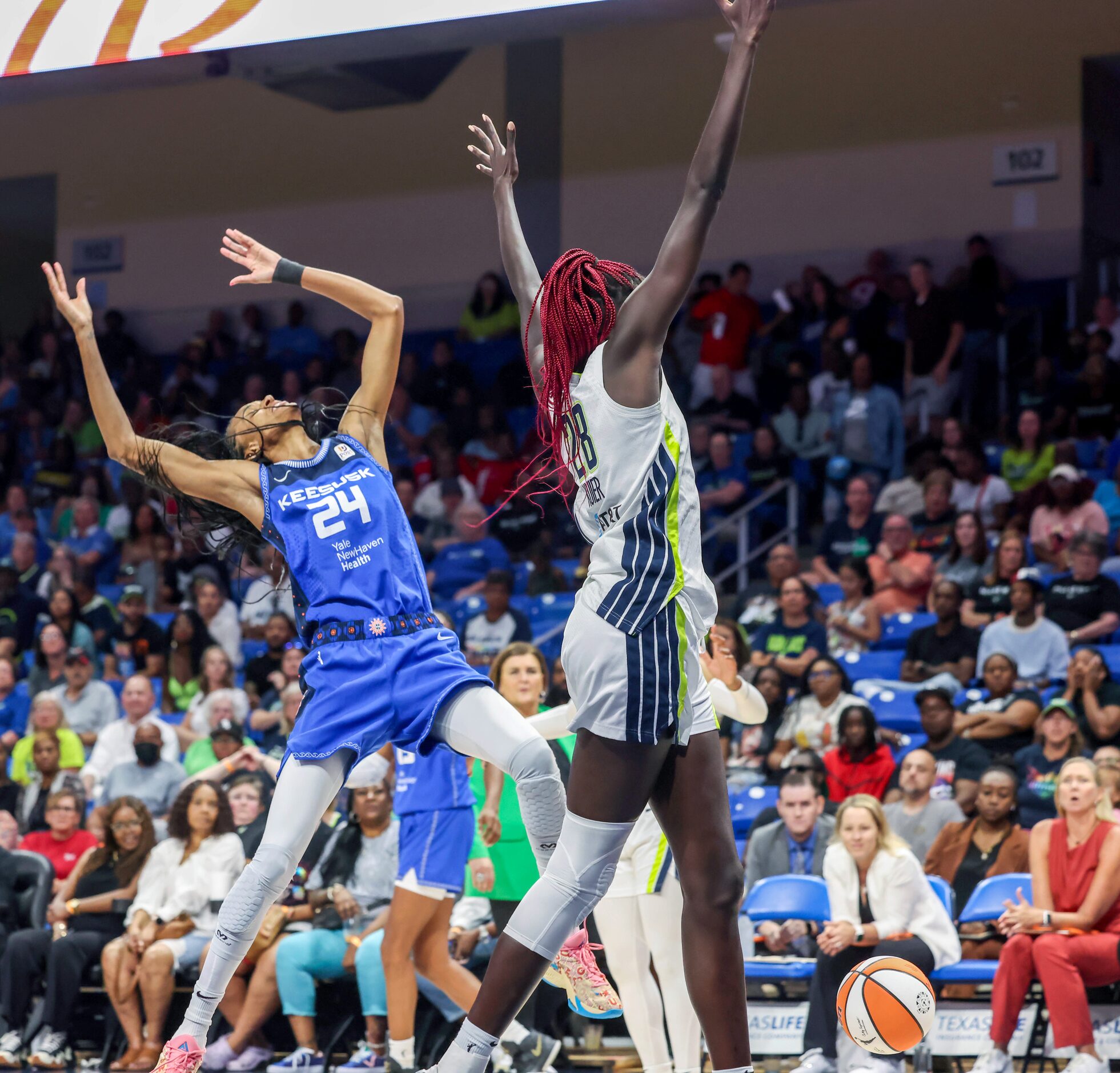 Connecticut Sun forward DeWanna Bonner (24) falls backwards after losing control of the ball...