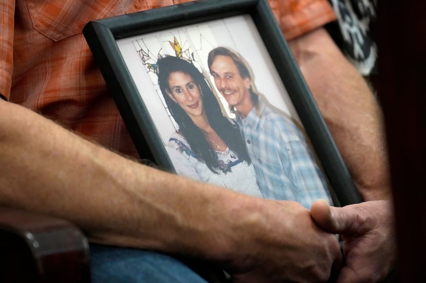 Family members of Dennis Tuttle and Rhogena Nicholas brought a photograph of the couple to...