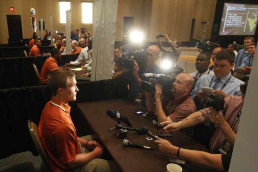 Texas quarterback David Ash, front, talks to the media during the Big 12 media days at the...