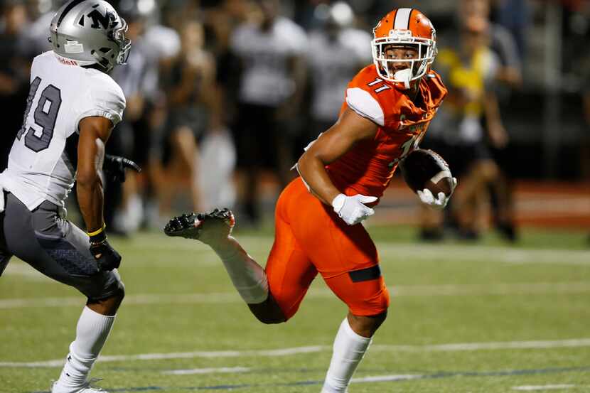 Rockwall's Jaxon Smith-Njigba (right) scores a touchdown against Arlington Martin on...