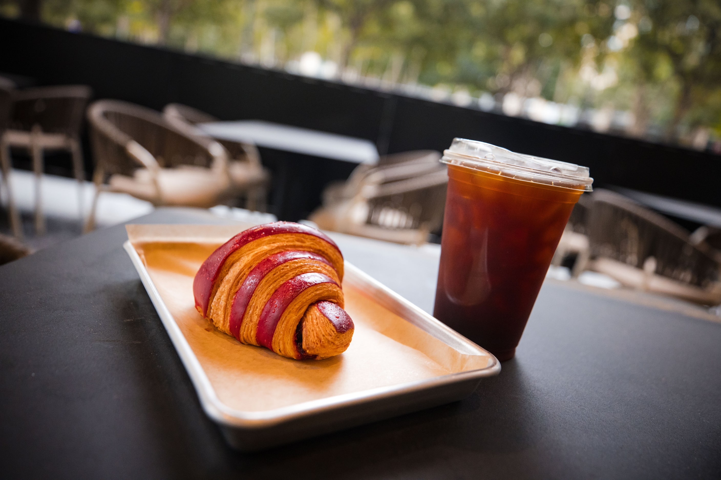 Eating breakfast? Here's a croissant and an iced coffee at Victory Social in Dallas.