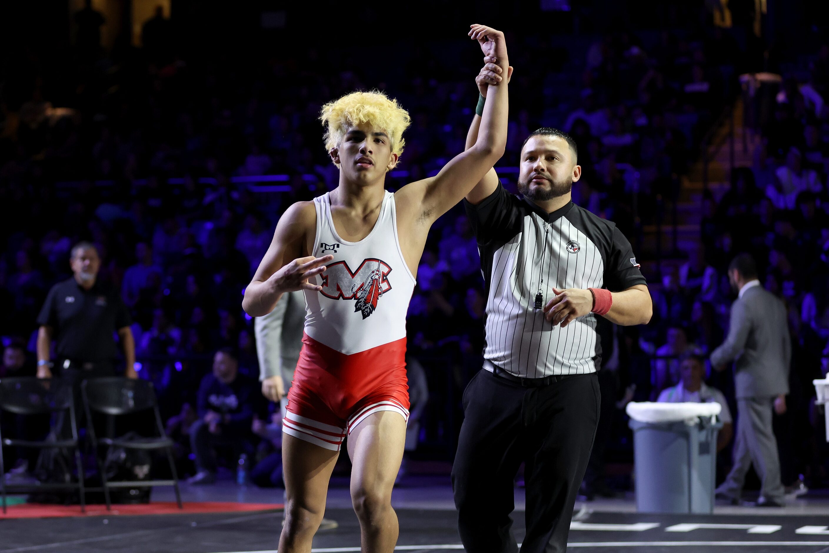 Isaak Arevalo (red) of Arlington Martin celebrates after defeating Jonah Arellano of Austin...