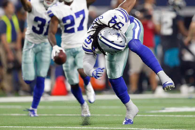 Dallas Cowboys linebacker Jaylon Smith (54) swipes the ground after forcing a fumble that...
