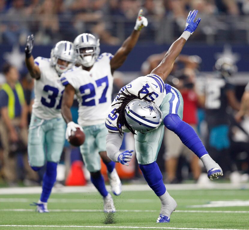 Dallas Cowboys linebacker Jaylon Smith (54) swipes the ground after forcing a fumble that...