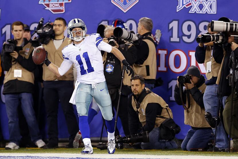 Dallas Cowboys wide receiver Cole Beasley (11) throws the ball as he celebrates his long...