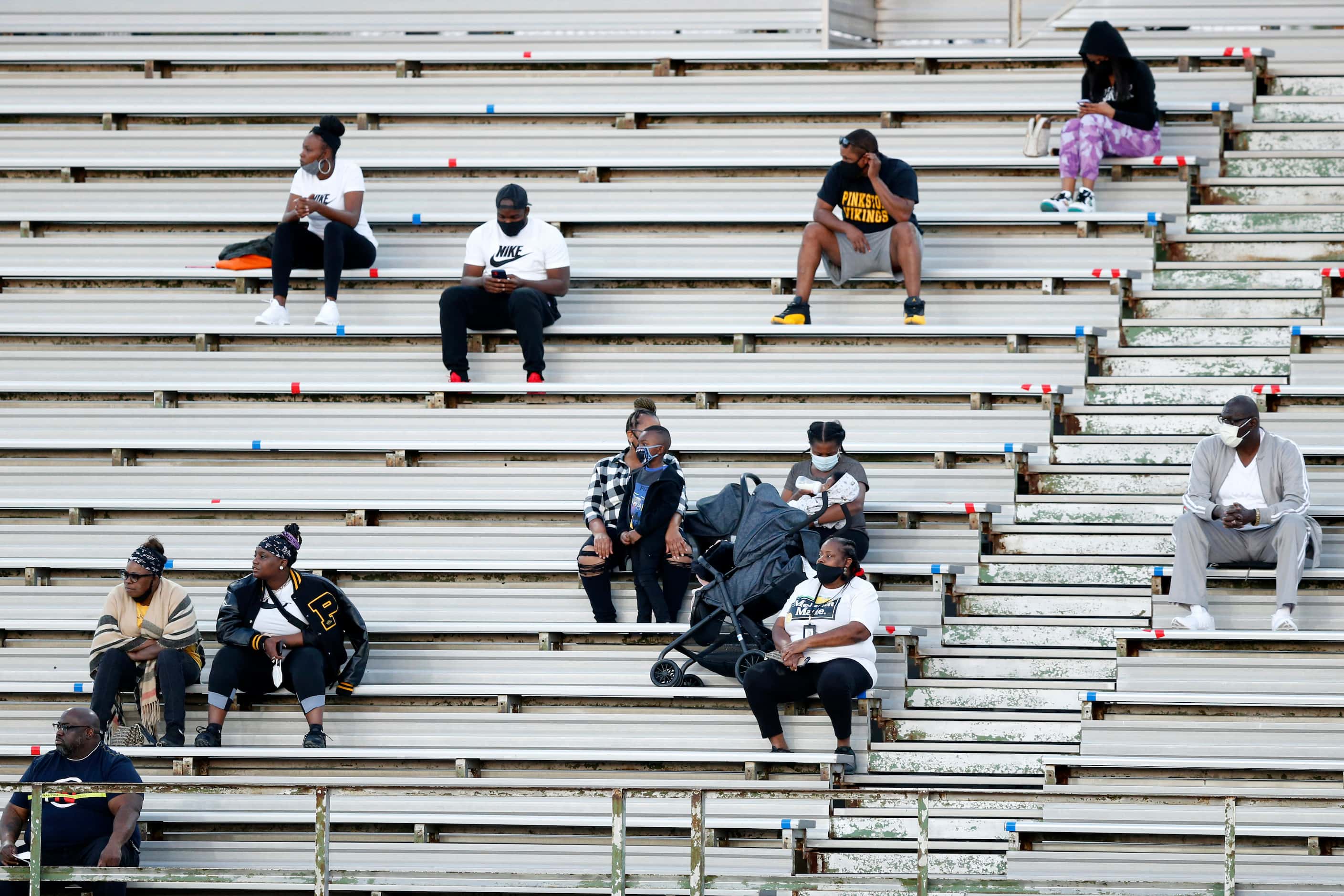 Thomas Jefferson and Pinkston football fans socially distance in the stands at Loos stadium...