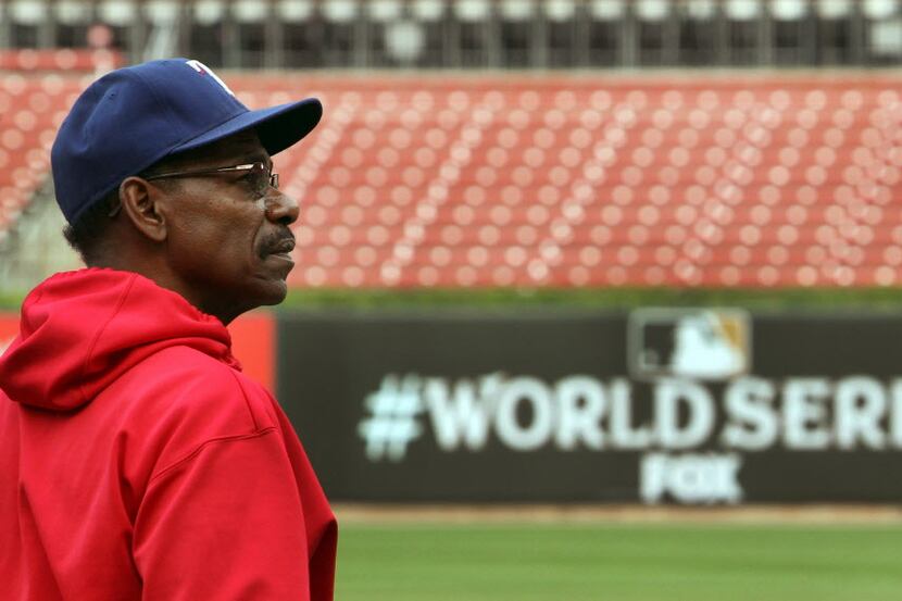 Texas manager ROn Washington gazes around the park as he pauses during batting practice...