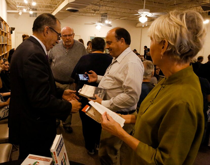 Alfredo Corchado signs copies of his memoir, Homelands and takes pictures with people at The...