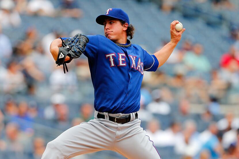 Derek Holland of the Texas Rangers pitches against the New York Yankees at Yankee Stadium on...