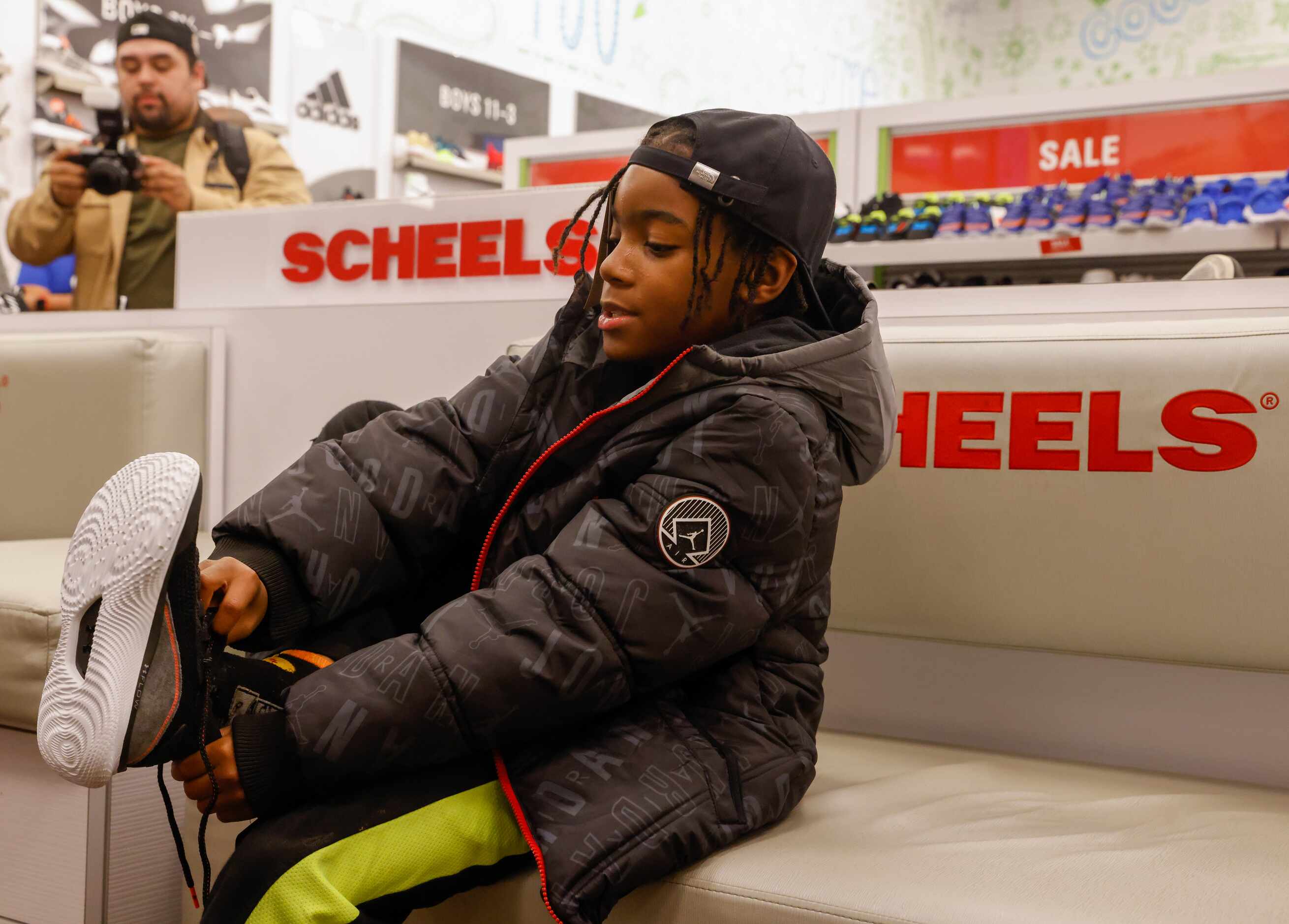Derrick Givens, Jr., 9, tries on a pair of shoes at Scheels in The Colony during a Dallas...