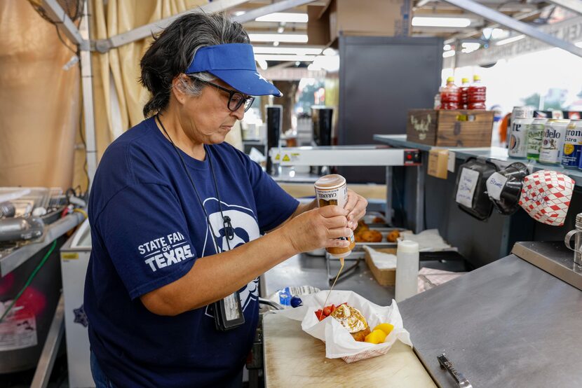 Denise Garza de la Cruz prepares a deep fried chocolate tres leches cake at the State Fair...