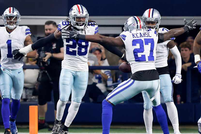 Dallas Cowboys safety Malik Hooker (28) is congratulated on his pick six by safety Jayron...