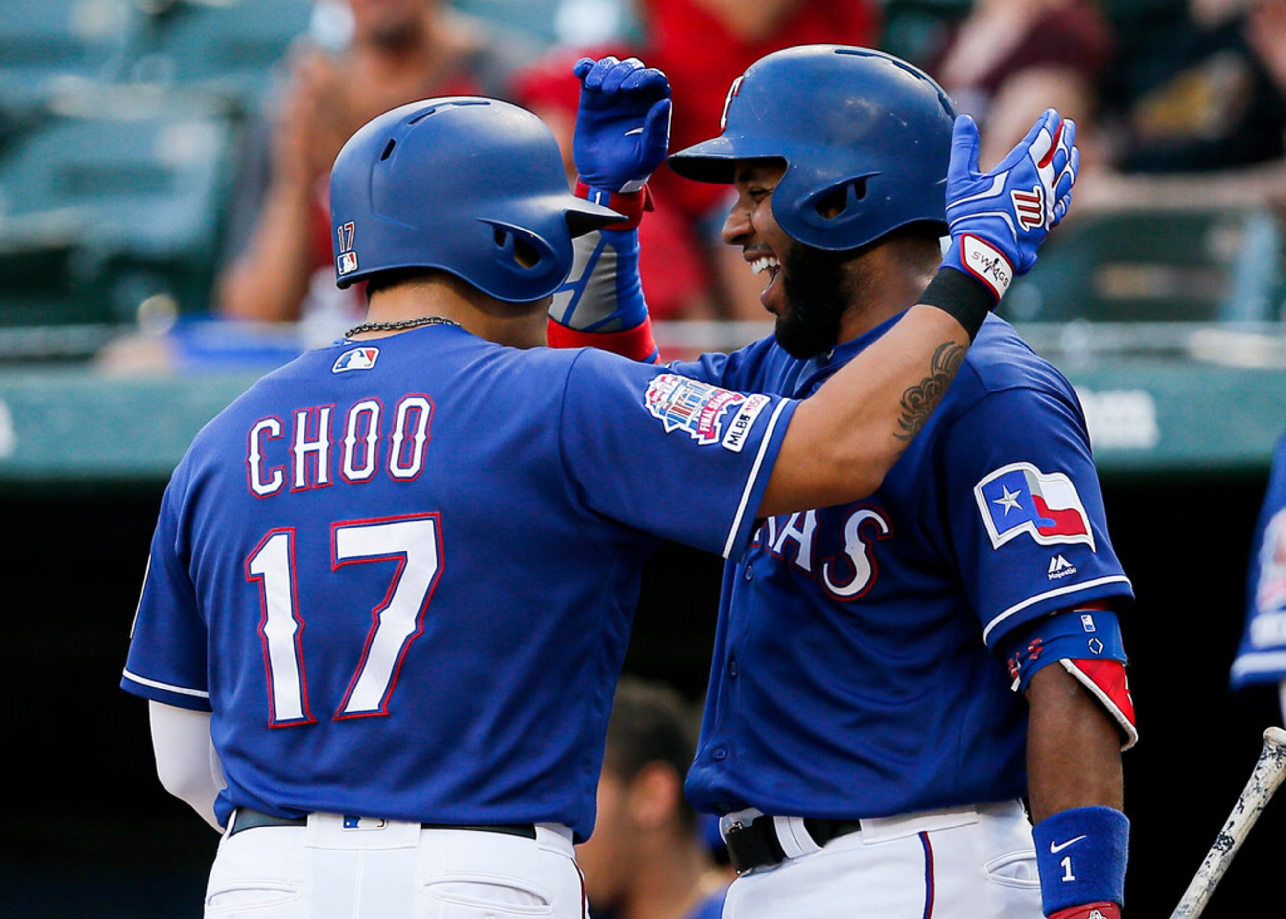 Texas Rangers' Shin-Soo Choo (17) is congratulated by Elvis Andrus after hitting a solo home...