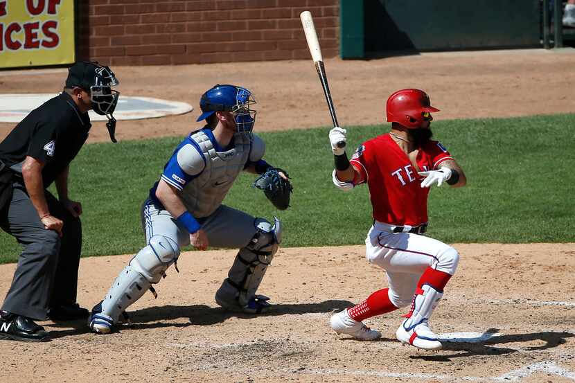 ARLINGTON, TX - MAY 5: Rougned Odor #12 of the Texas Rangers drives in a run with a single...