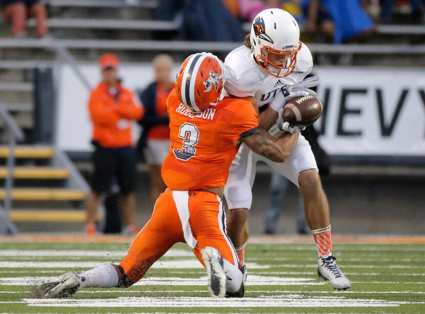 UTSA wide receiver Aron Taylor is tackled by UTEP defensive back Traun Roberson during an...