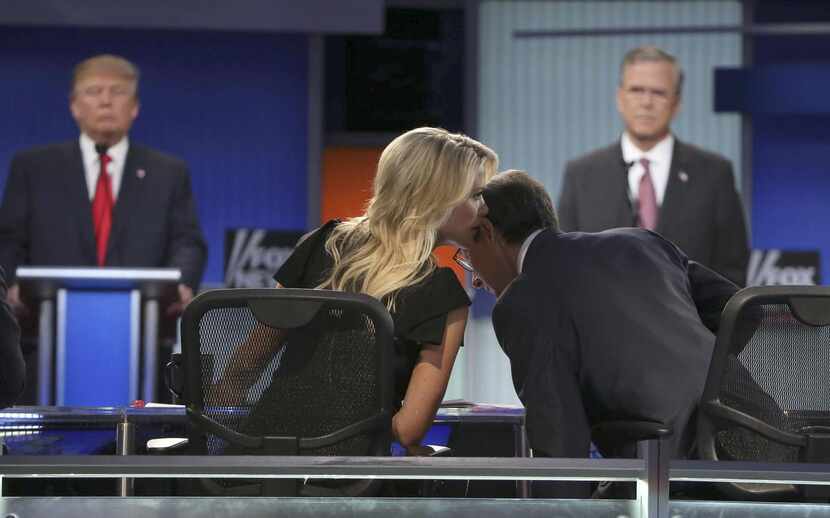 
Megyn Kelly
whispers to
Chris Wallace,
her fellow Fox News moderator, during the first...