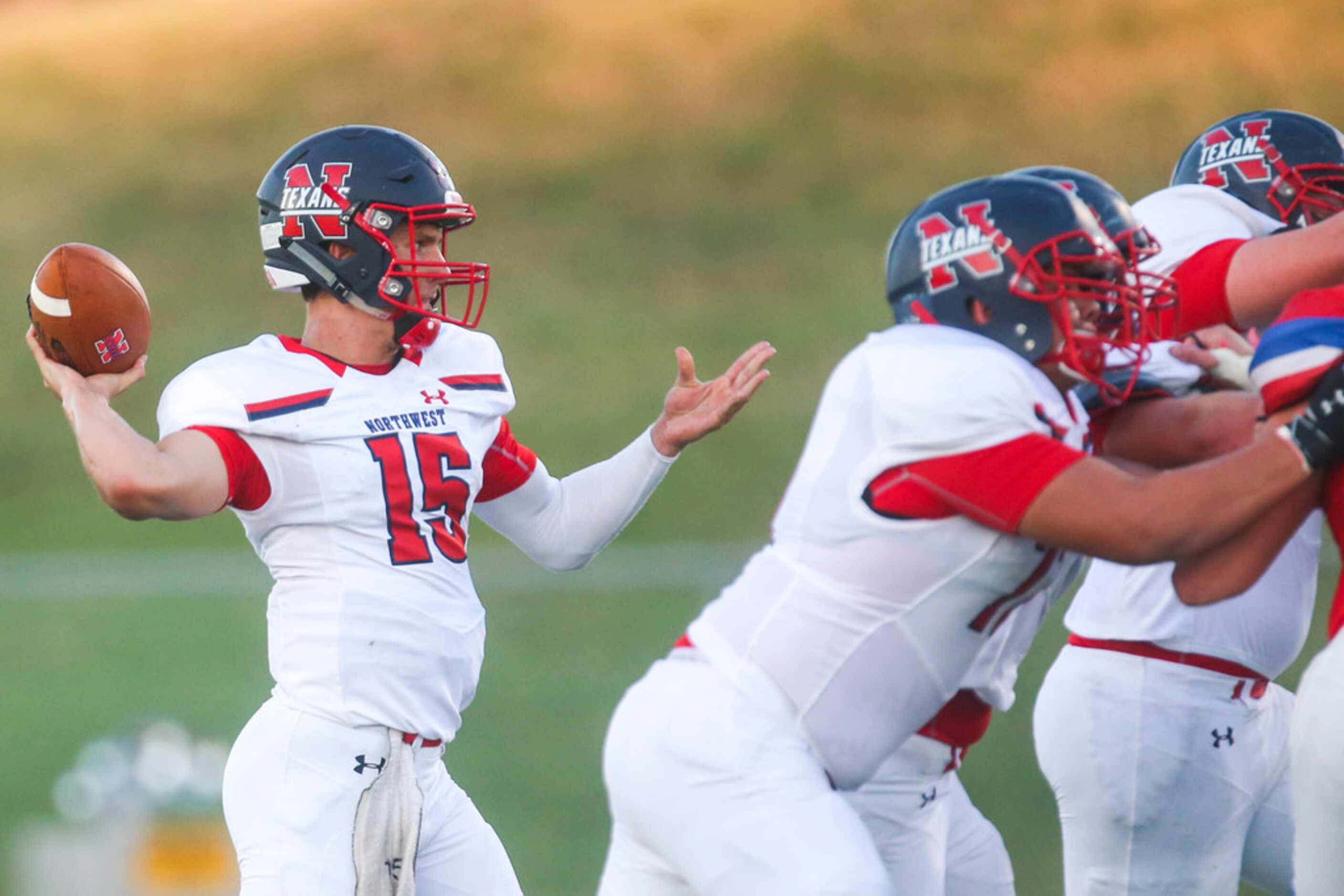 Northwest quarterback Austin Ahmad (15) looks to make a pass during the first half of a high...