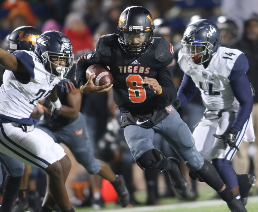 Lancaster Tigers quarterback Trevor Hatton (8) bolts through the Wylie East secondary as...