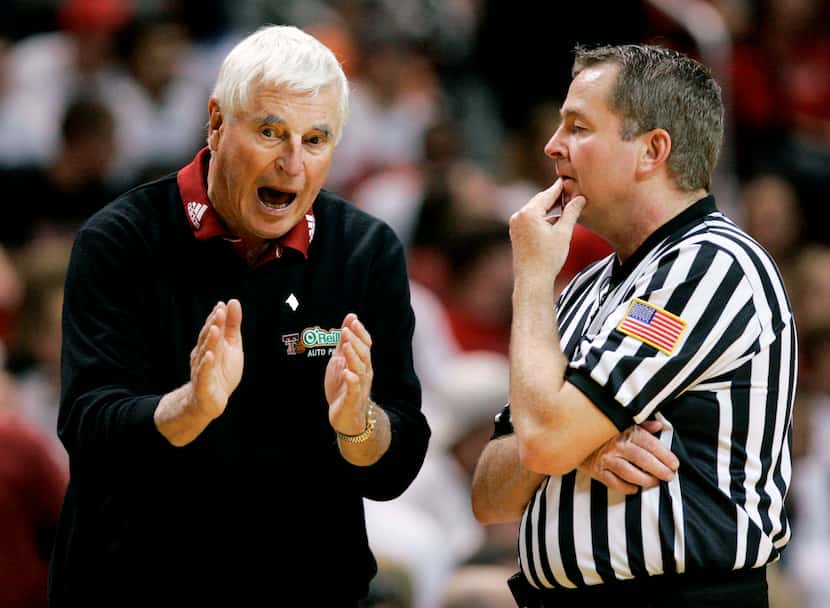 Texas Tech coach Bob Knight, left, argues a call with an NCAA official during a basketball...