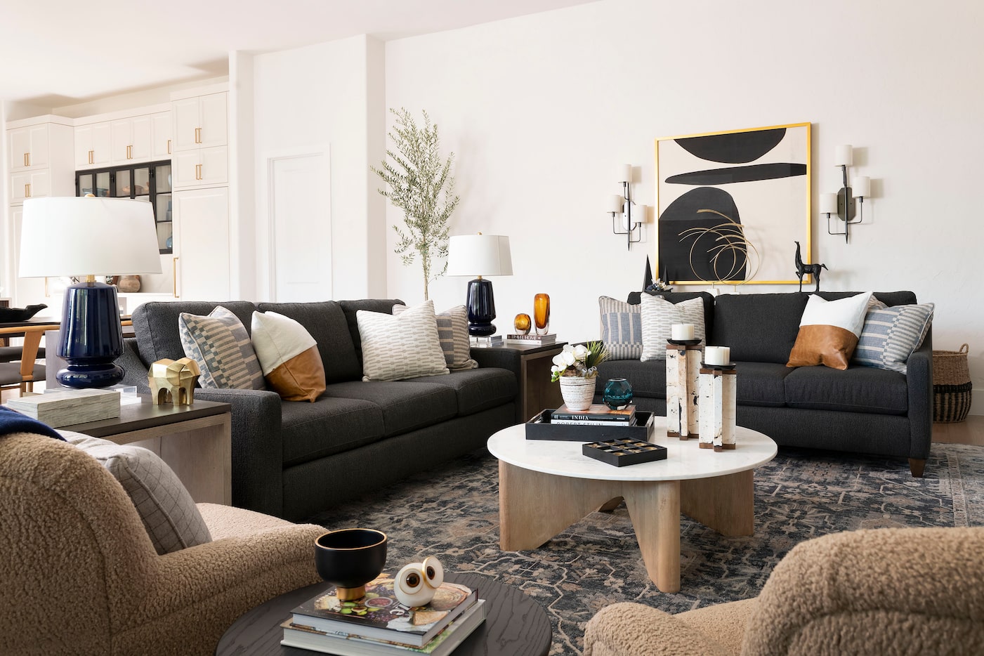 Living room with sofas and throw pillows and a round coffee table