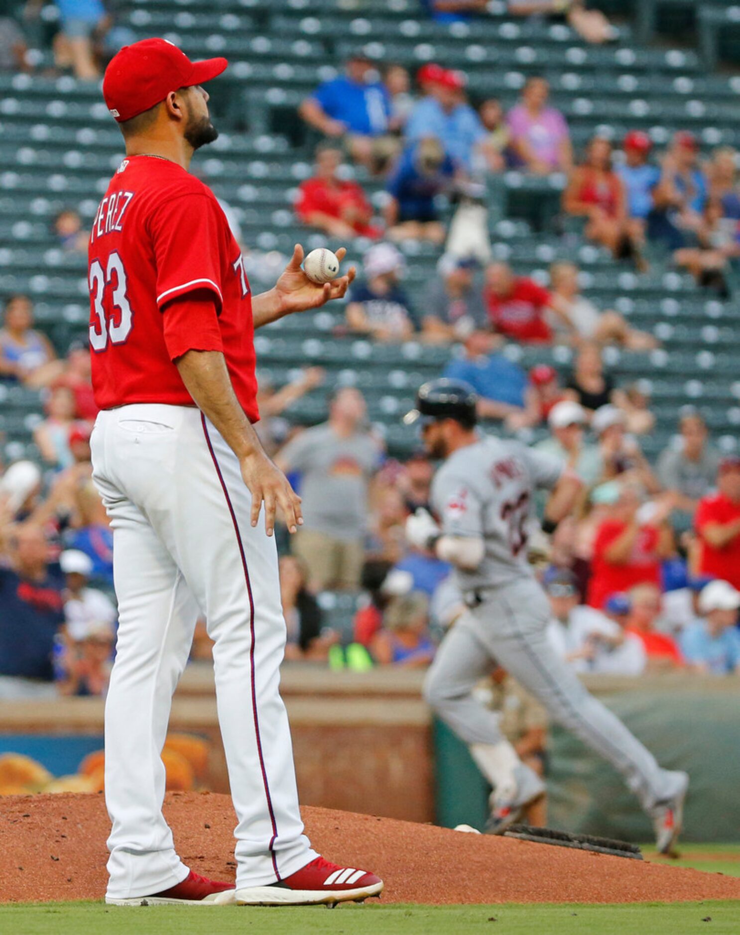 Texas Rangers starting pitcher Martin Perez (33) watches as Cleveland Indians second baseman...