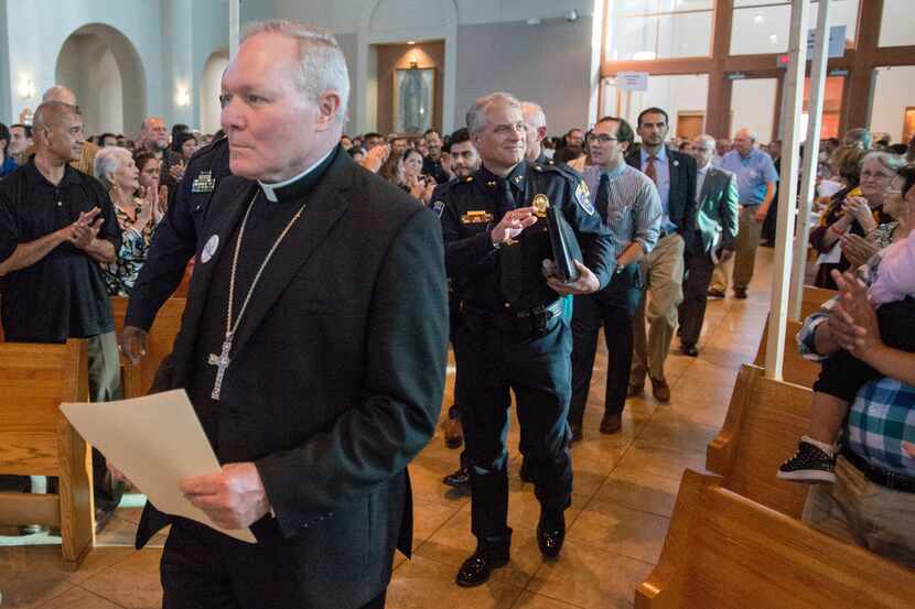 Bishop Edward J. Burns of the Catholic Diocese of Dallas was followed to the dais by a...