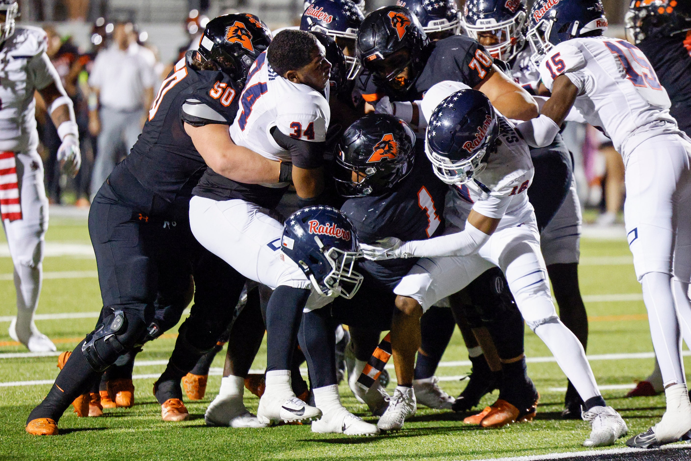 Denton Ryan linebacker Demari Ruth (34) works to tackle Aledo running back Raycine Guillory...