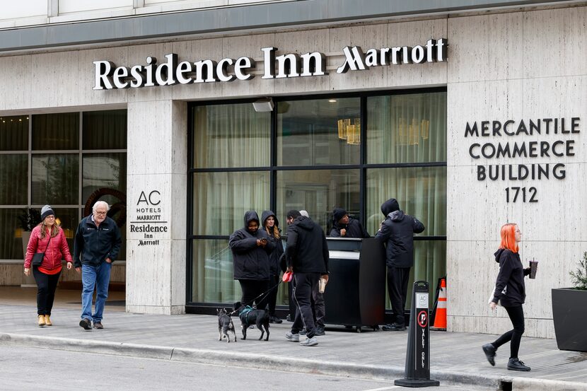 Pedestrians walk outside the AC Hotel and Residence Inn in downtown Dallas. Grapevine-based...