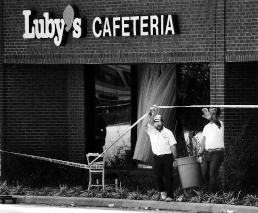 Workers remove debris from the scene of the Luby's massacre in 1991.