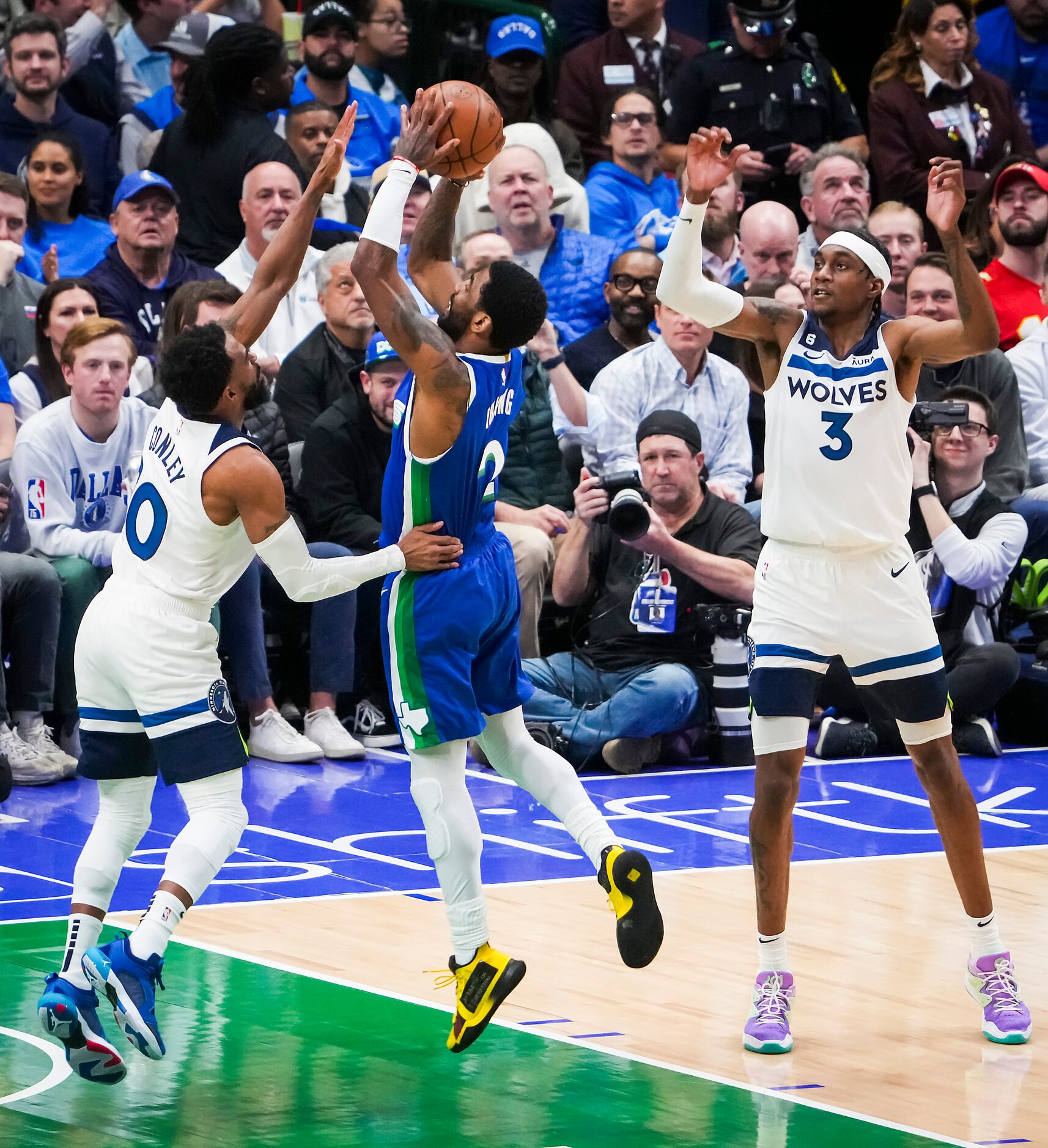 Dallas Mavericks guard Kyrie Irving (2) shoots past Minnesota Timberwolves guard Mike Conley...