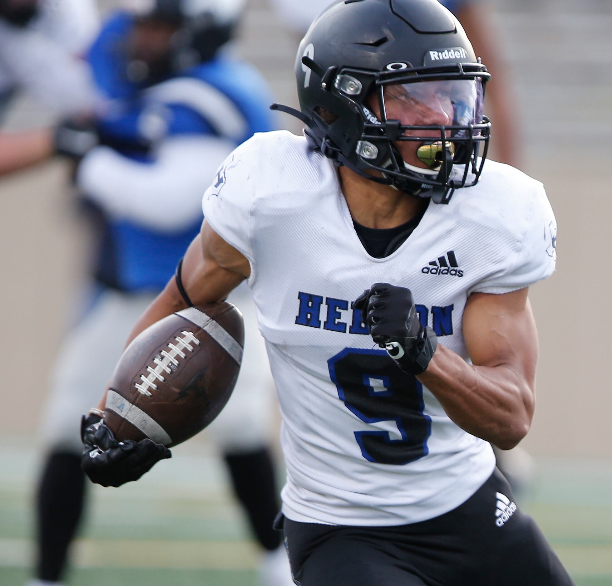 Hebron High School wide receiver Nick Harris (9) runs with the football during the second...