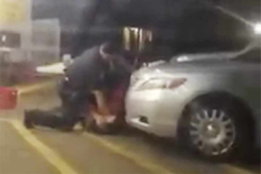 Alton Sterling is detained by two Baton Rouge police officers outside a convenience store....