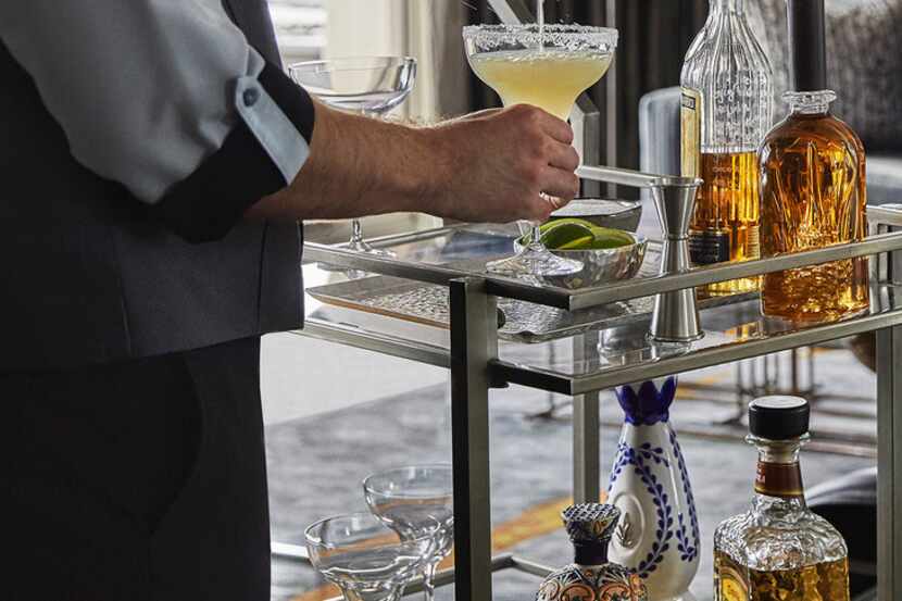 A mixologist at the Four Seasons Austin mixes a drink from the new room-service margarita cart.
