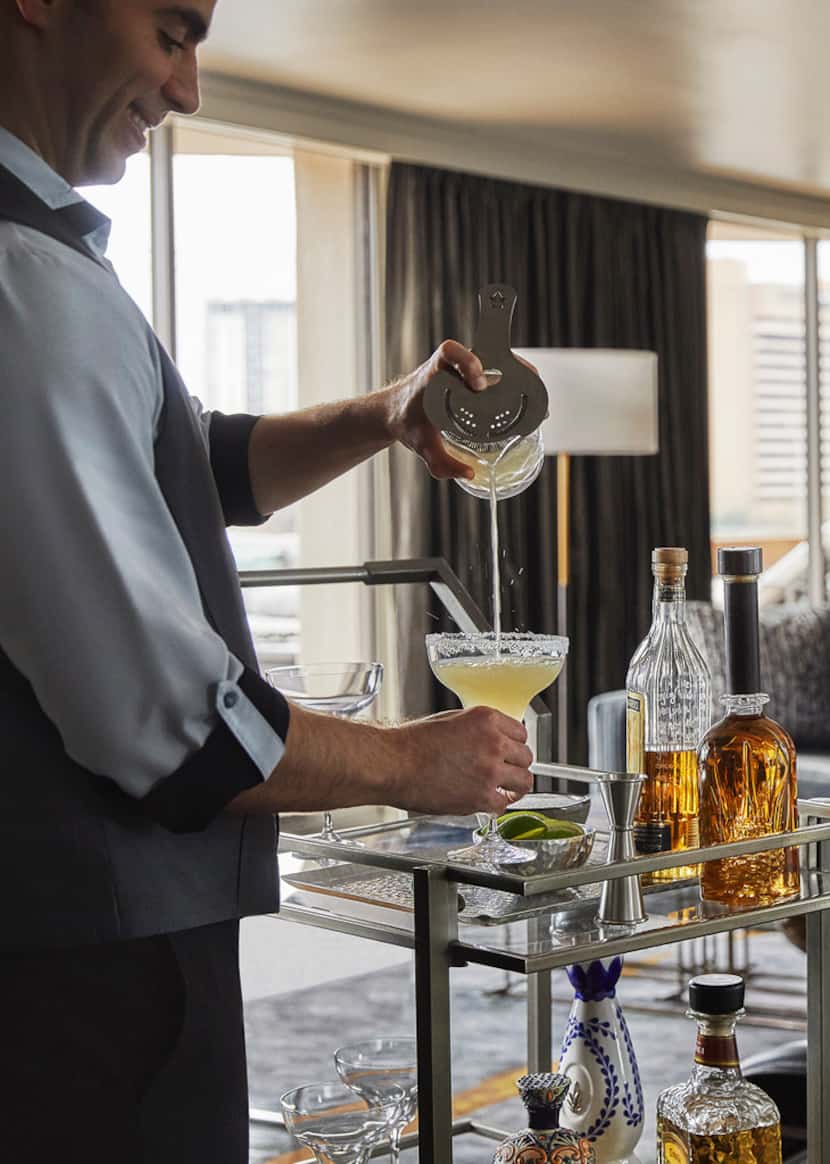 A mixologist at the Four Seasons Austin mixes a drink from the new room-service margarita cart.