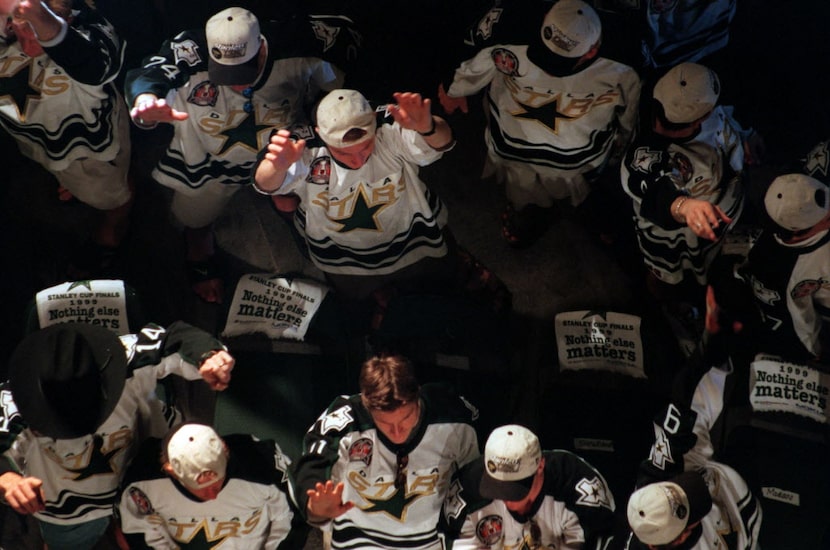 Stars players acknowledge the crowd on the stage at the victory celebration at Reunion Arena...