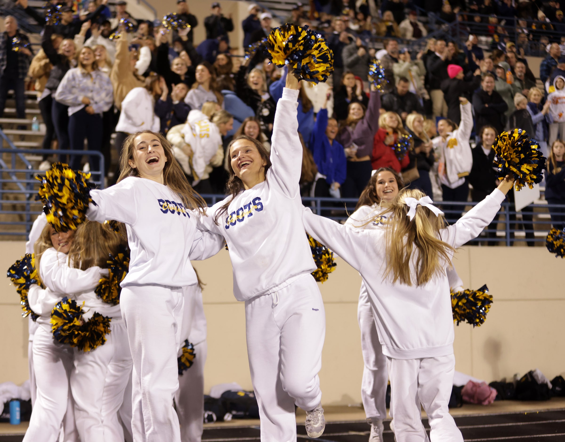 Highland Park cheerleaders celebrate a touchdown during a football playoff game against...