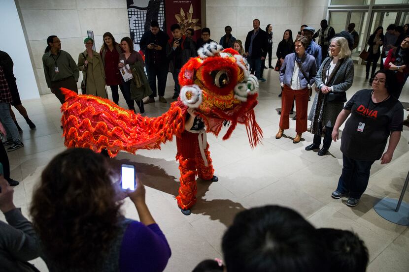 Patrons watch a lion dance performance at the Dallas Museum of Art's Late Night at the DMA...