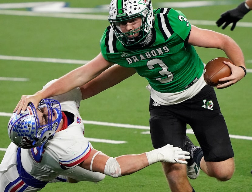 Southlake Carroll quarterback Quinn Ewers (3) pushes past Austin Westlake linebacker...