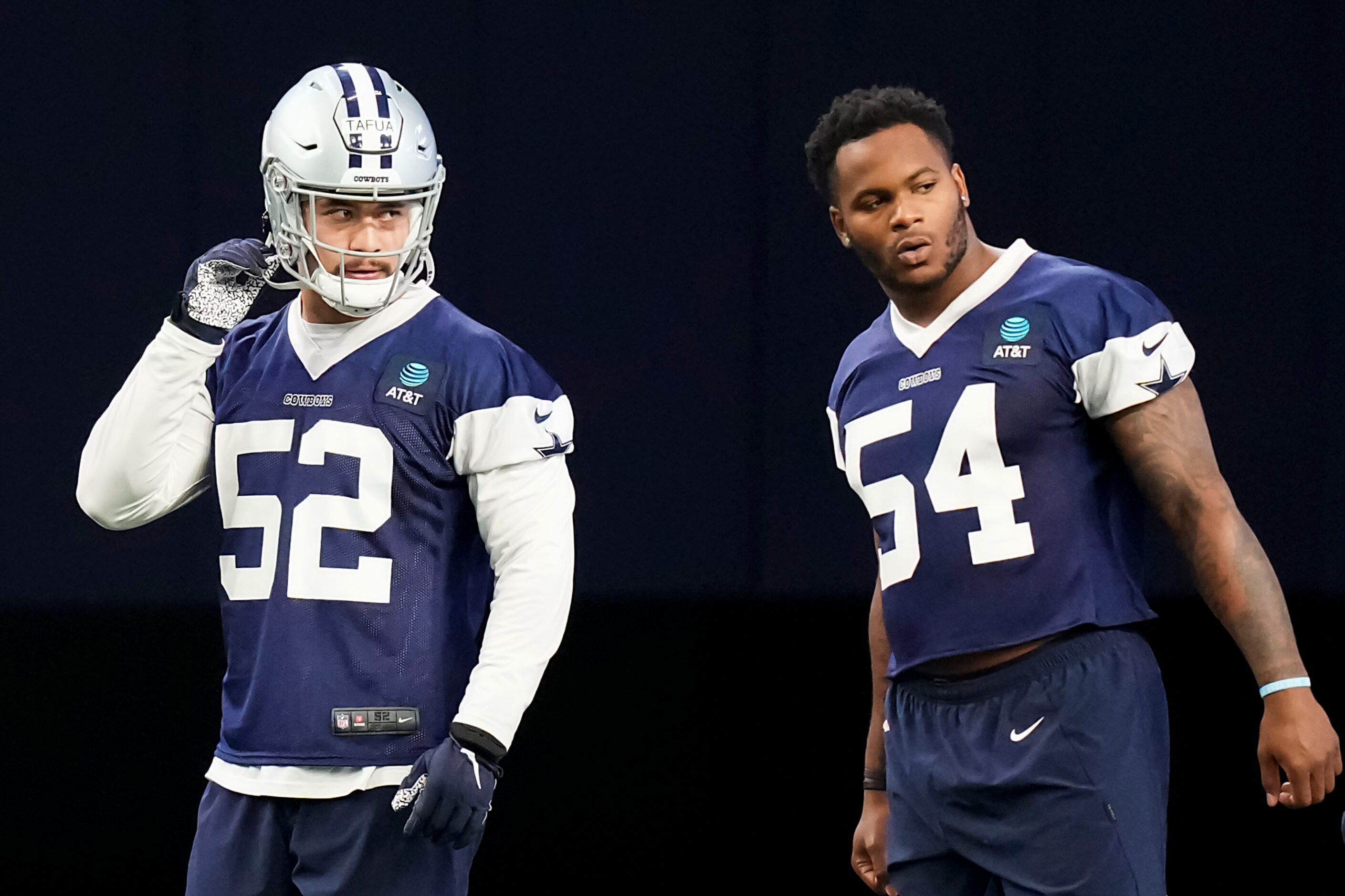 Dallas Cowboys defensive end Mike Tafua (52) and defensive end Sam Williams (54) stretch...