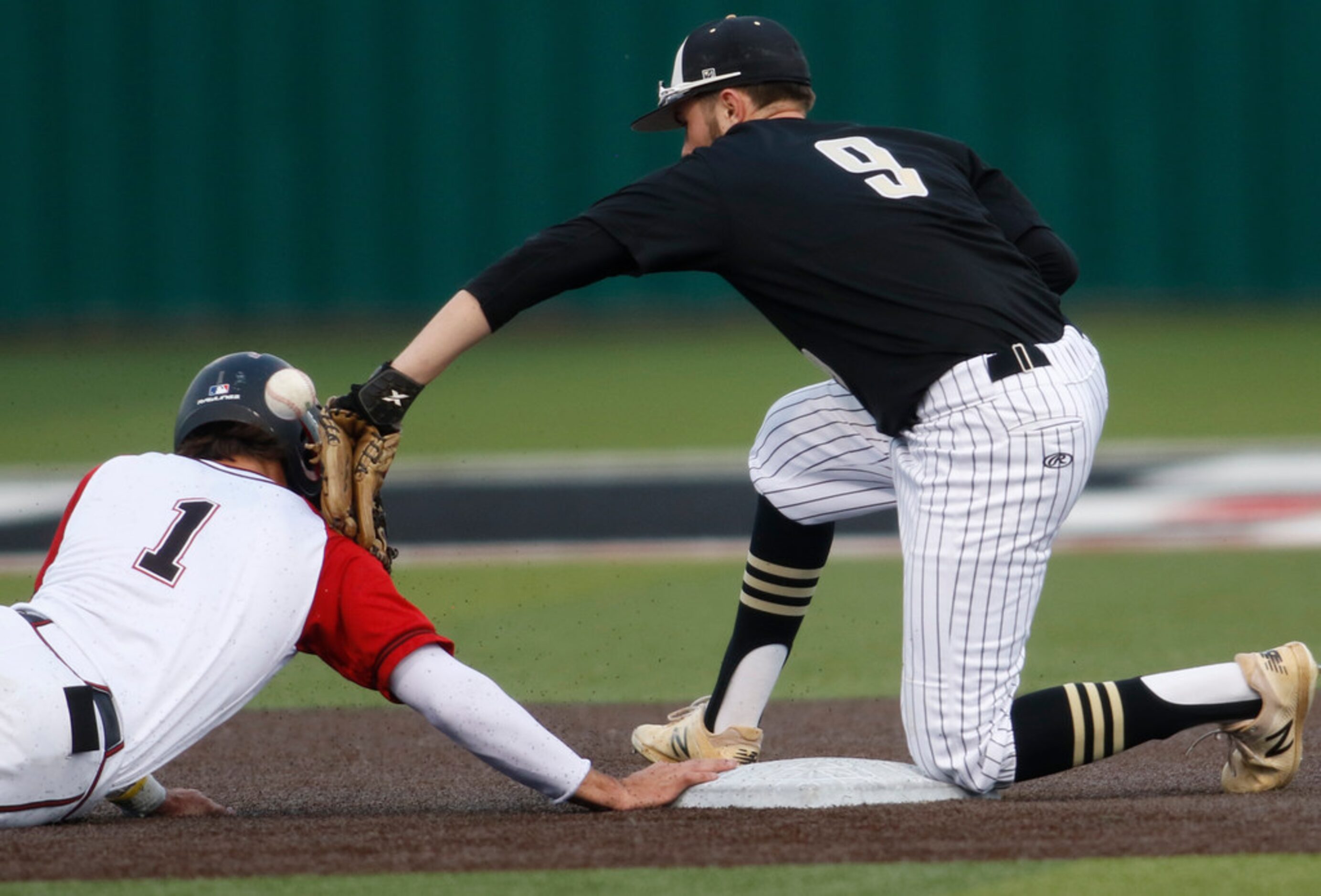 Rockwall Heath baserunner Casey Curtin (1) jars the ball loose from the tag of The Colony...