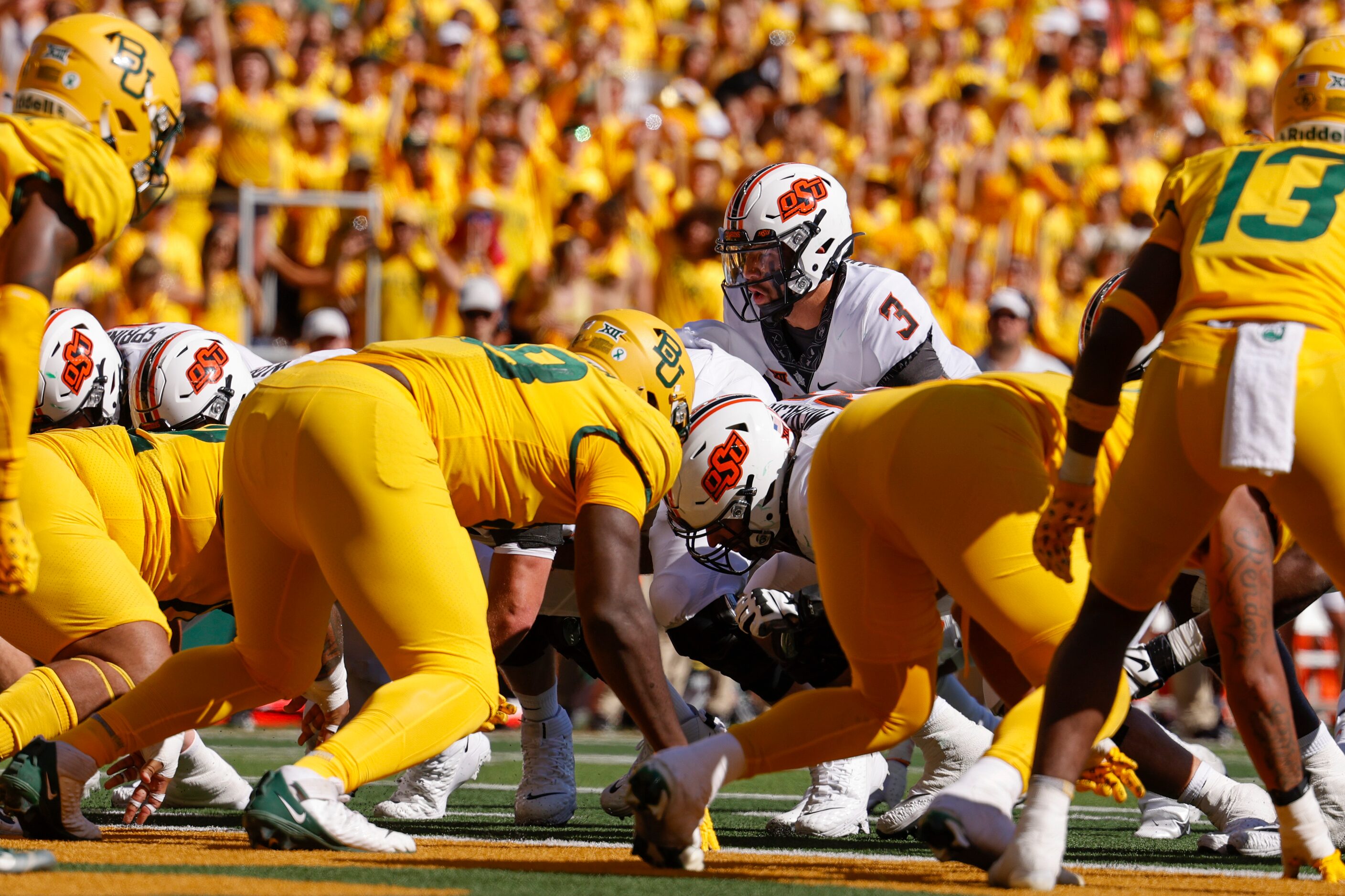 Oklahoma State quarterback Spencer Sanders (3) takes the snap as he runs the ball into the...