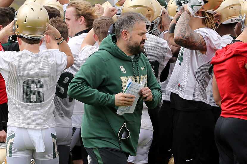 Baylor coach Matt Rhule walks away from a huddle during the team's first day of spring NCAA...