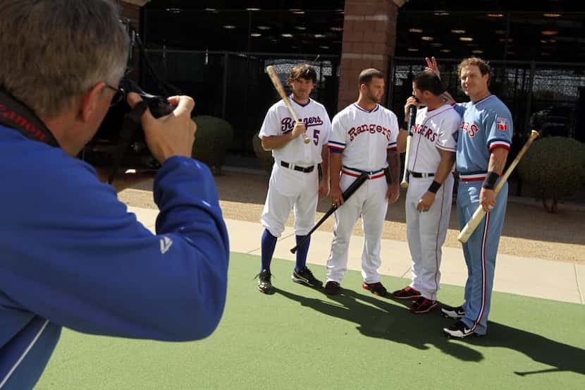(From left) Texas Rangers team photographer Brad Newton takes a portrait of players Ian...
