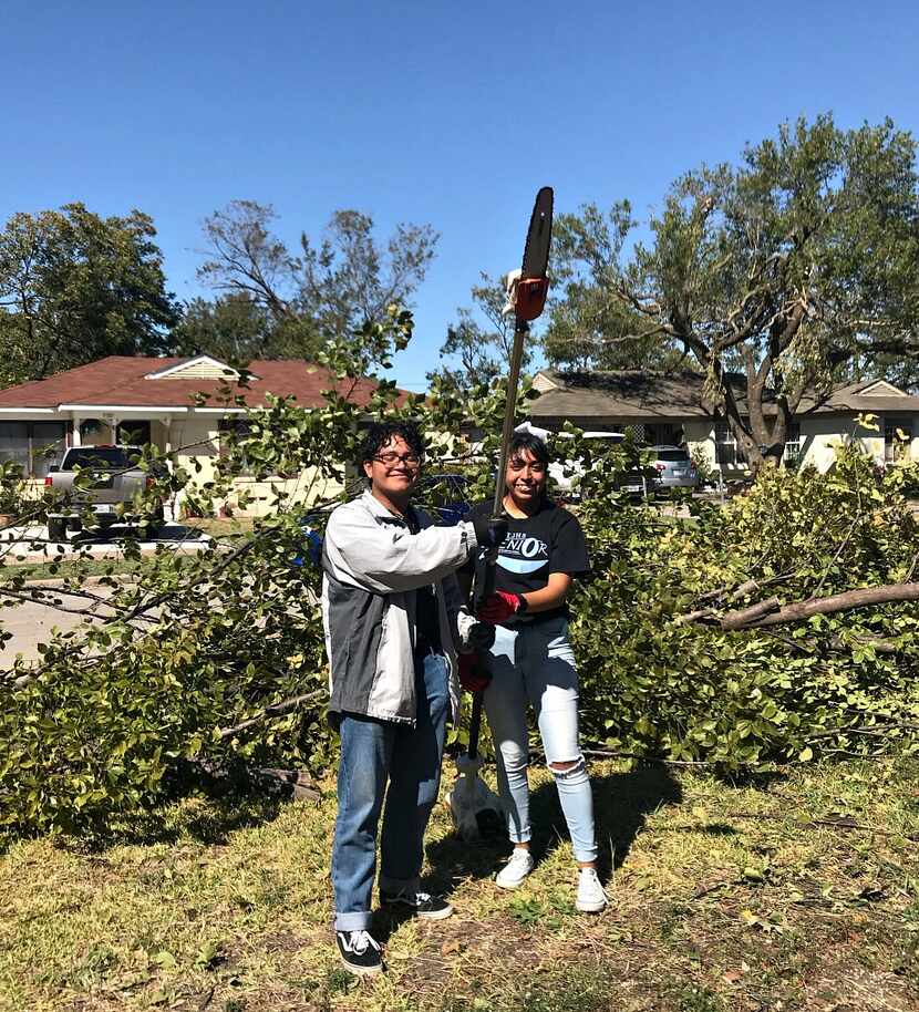 Justin Barron, left, and Dayse Flores, two TJ seniors, helped clear splintered trees in...