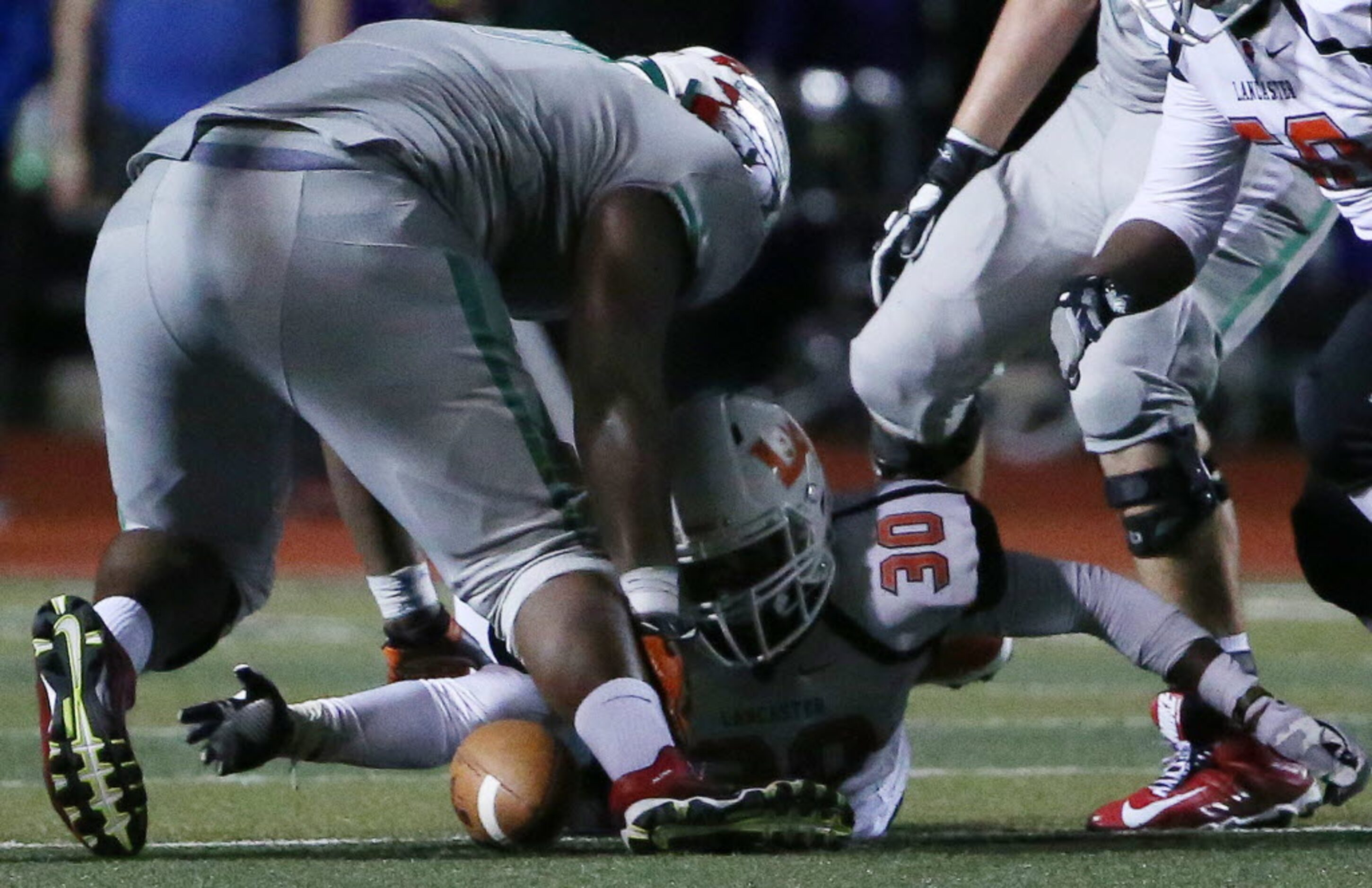 Lancaster linebacker Ahndre Hughes (30) recovers a Waxahachie fumble in the fourth quarter...