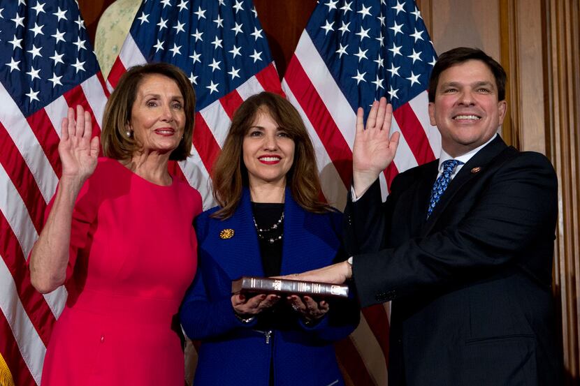 House Speaker Nancy Pelosi of Calif., administers the House oath of office to Rep. Vicente...