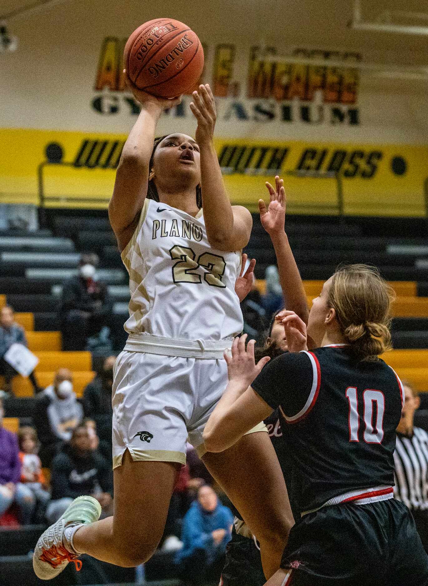 Plano East High School Donavia Hall (23) jumps up for a basket during the first quarter of...